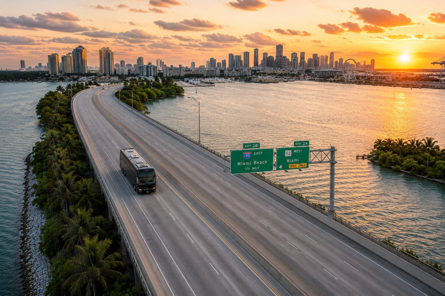 An Miami Bus Company motorcoach on the I-195 causeway at sunset, Miami skyline in the background